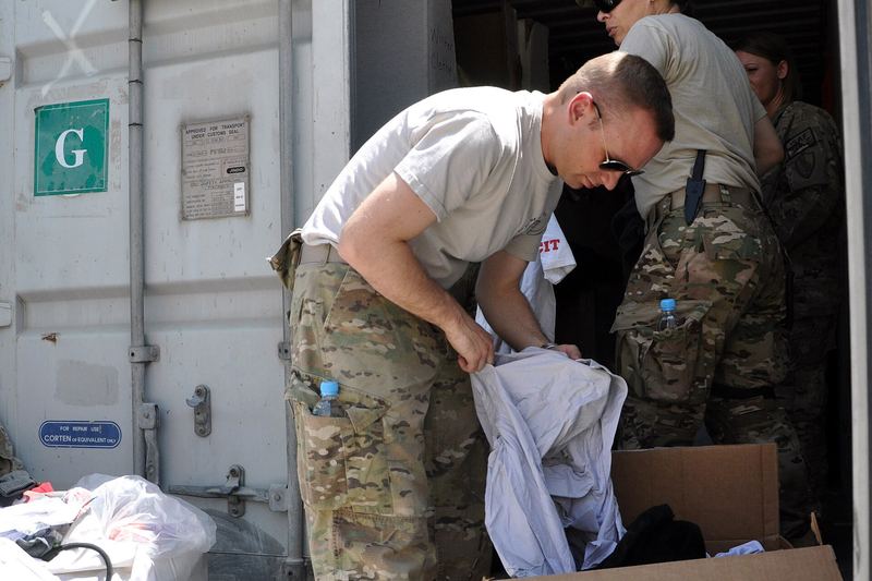 U.S. Navy Petty Officer 2nd Class Todd Gilbert, front, and Army Sgt. 1st Class Mary Good, both with Combined Joint Interagency Task Force 435, sort boxes of clo